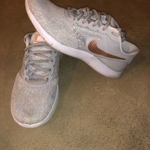 Grey Nike sneakers with metallic gold swoosh